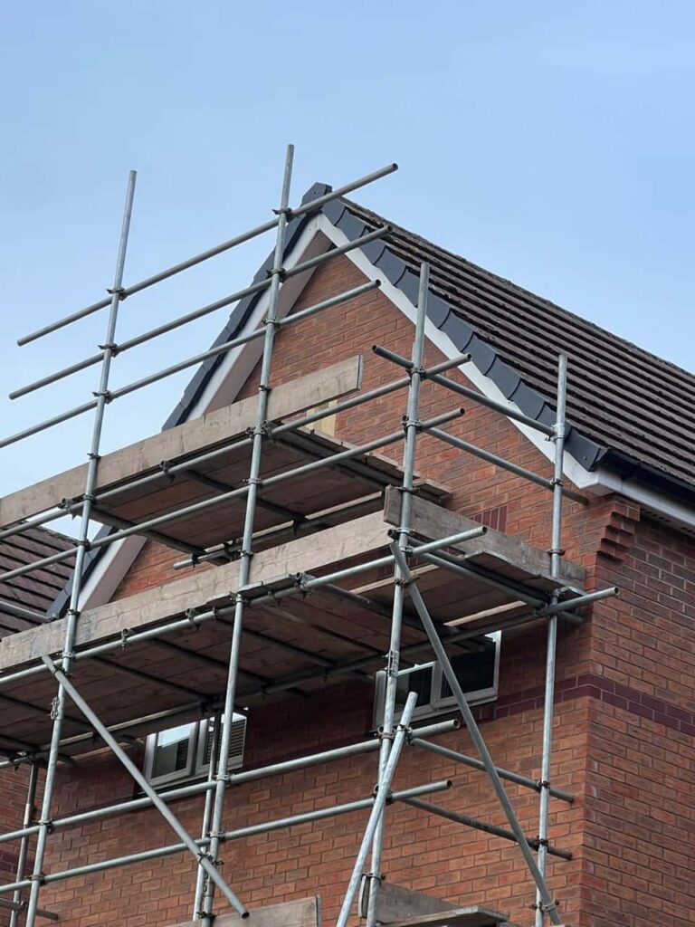 This is a photo of a roof which has just been repaired. There is a scaffold located at the gable end for access onto the roof. Works carried out by Belper Roofing Repairs